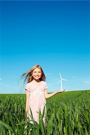 remote power - Girl with wind turbine in hand Stock Photo - Premium Royalty-Free, Code: 649-03621519