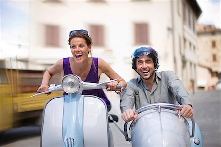 driving scooter women - Couple driving a vespa Stock Photo - Premium Royalty-Free, Code: 649-03621748