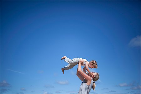 parent and child and outside and sky - Woman holding son Stock Photo - Premium Royalty-Free, Code: 649-03622293
