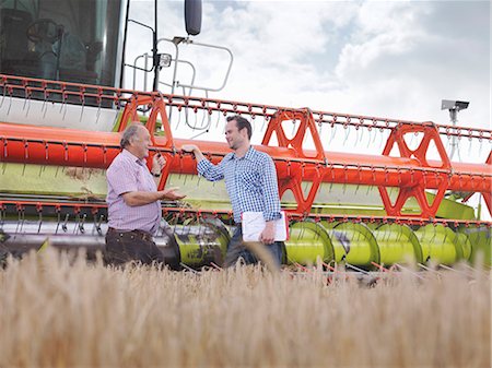 Farmers in front of combine harvester Stock Photo - Premium Royalty-Free, Code: 649-03622425