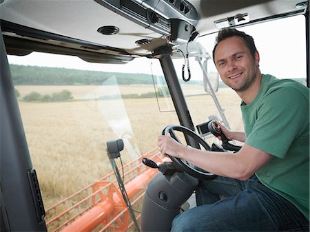 Farmer driving combine harvester Stock Photo - Premium Royalty-Free, Code: 649-03622437