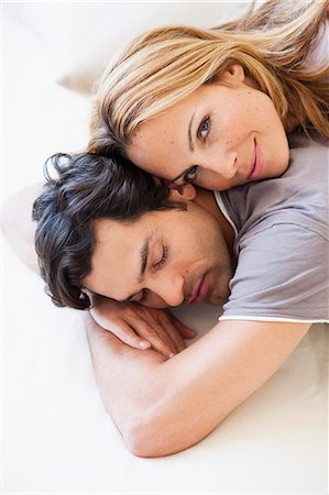 sleeping in female partner hug pic - young couple snuggling in bed Stock Photo - Premium Royalty-Free, Code: 649-03666091
