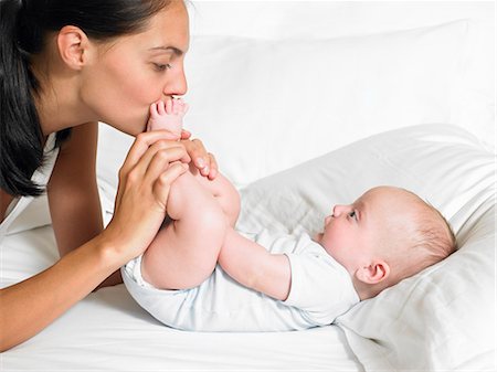 family tickling - Mother kissing her new-born baby's feet Stock Photo - Premium Royalty-Free, Code: 649-03666308