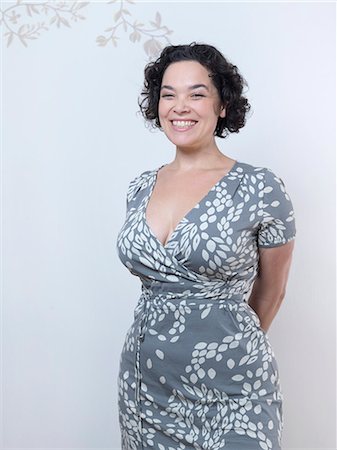 Curvy Woman standing up and smiling. Stock Photo - Premium Royalty-Free, Code: 649-03666807