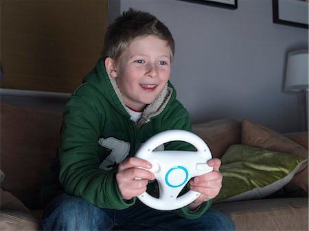 Boy, 11 playing driving game Stock Photo - Premium Royalty-Free, Code: 649-03667152