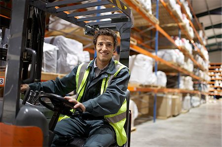 Worker on forklift, smiling to camera Stock Photo - Premium Royalty-Free, Code: 649-03667180