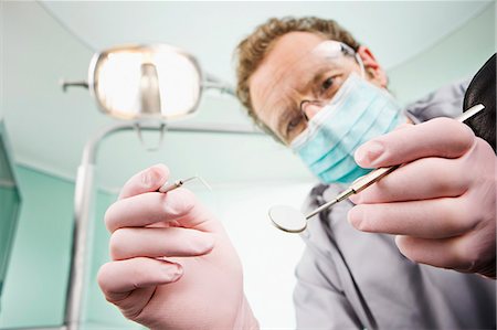 dentist and equipment - A dentist examining a patient Stock Photo - Premium Royalty-Free, Code: 649-03667275