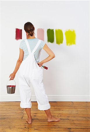 decorating a wall - Woman looking at colour swatches on wall Stock Photo - Premium Royalty-Free, Code: 649-03667444