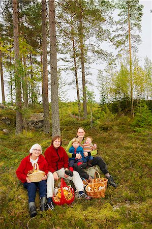 Family with mushroom baskets in forest Stock Photo - Premium Royalty-Free, Code: 649-03667470