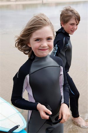 females posing together at the beach - Portrait of young surfer on beach Stock Photo - Premium Royalty-Free, Code: 649-03768897