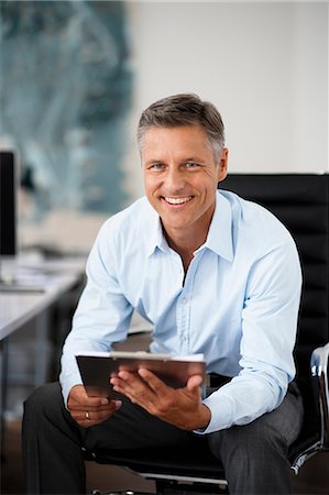 smiling businessman white hair - Businessman holding clipboard Stock Photo - Premium Royalty-Free, Code: 649-03769160