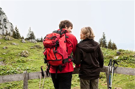 Hiking couple resting on fence Stock Photo - Premium Royalty-Free, Code: 649-03769223