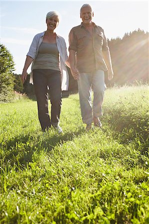 Senior couple walking in meadows Stock Photo - Premium Royalty-Free, Code: 649-03769264