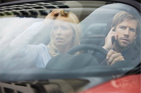 reflection of woman in car - Business people sitting in electric car Stock Photo - Premium Royalty-Free, Code: 649-03769911