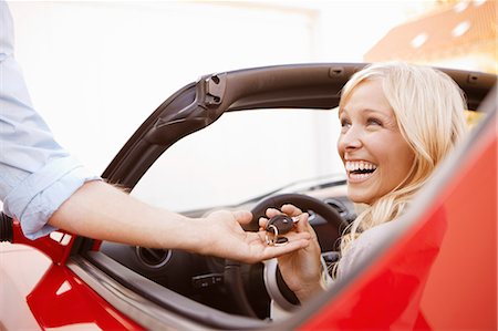 rich man in a car - Girl receiving keys to an electric car Stock Photo - Premium Royalty-Free, Code: 649-03769941