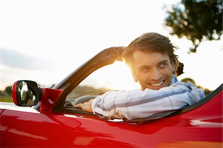 red car - Man sitting in an electric sports car Stock Photo - Premium Royalty-Free, Code: 649-03769959