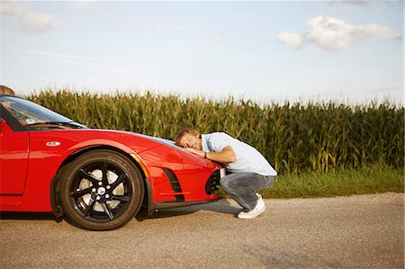 sports car and person - Man hugging his electric sports car Stock Photo - Premium Royalty-Free, Code: 649-03769951