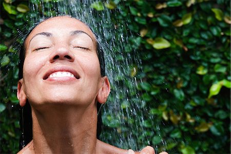 fresh face female in her thirties smiling - Smiling colored woman in the shower Stock Photo - Premium Royalty-Free, Code: 649-03774365