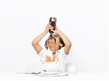 people sitting cutout white background - Boy eating chocolate sauce Stock Photo - Premium Royalty-Free, Code: 649-03774386