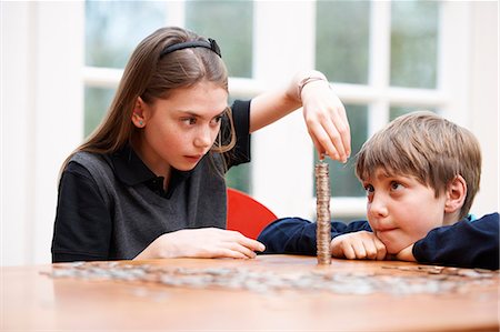 Children counting piles of money Stock Photo - Premium Royalty-Free, Code: 649-03774584