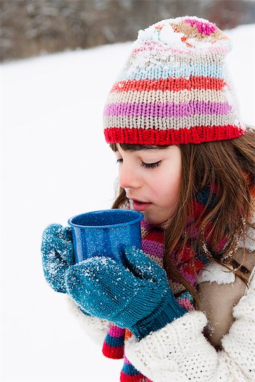 Girl having hot drink Stock Photo - Premium Royalty-Free, Image code: 649-03774910