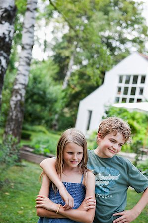 portrait boy arms crossed - Boy hugging girl in the garden Stock Photo - Premium Royalty-Free, Code: 649-03774978