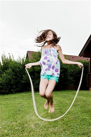 skipping ropes - Girl skipping in garden Stock Photo - Premium Royalty-Free, Code: 649-03775030