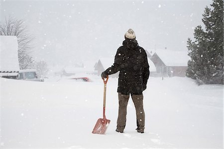 snow shovelling - Man standing in snow with shovel Stock Photo - Premium Royalty-Free, Code: 649-03775215