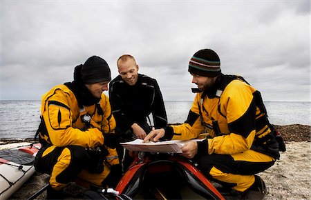 sports and kayaking - 3 men looking at map Stock Photo - Premium Royalty-Free, Code: 649-03775533