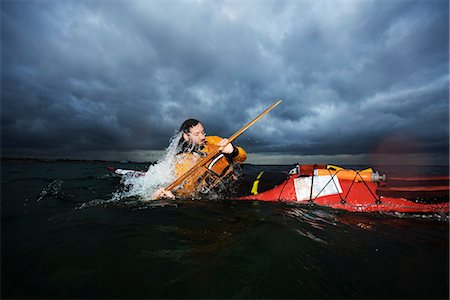 dramatizing - Man in kayak rotating Stock Photo - Premium Royalty-Free, Code: 649-03775548