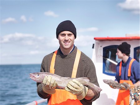 scale (animal covering) - Fishermen on boat holding fish Stock Photo - Premium Royalty-Free, Code: 649-03770296