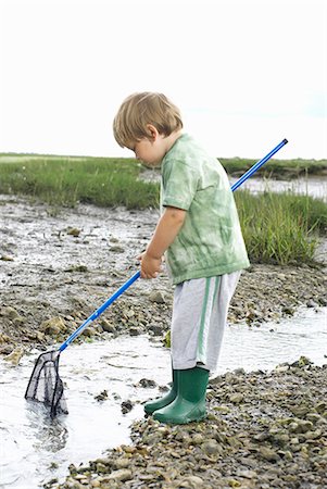 Young boy fishing with net Stock Photo - Premium Royalty-Free, Code: 649-03770445