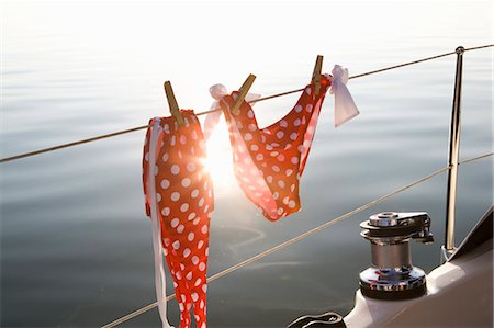 dangled - Bikini hanging on rail Stock Photo - Premium Royalty-Free, Code: 649-03770520