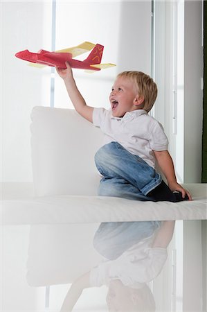preschooler - Young boy playing with toy plane Stock Photo - Premium Royalty-Free, Code: 649-03770668