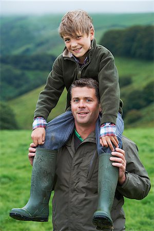 devon - Father giving son a piggy back in field Stock Photo - Premium Royalty-Free, Code: 649-03770856