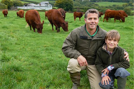 Father and son on farm with cows Stock Photo - Premium Royalty-Free, Code: 649-03770861