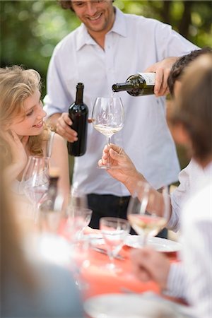 restaurants in tuscany italy - Man pours wine into glasses Stock Photo - Premium Royalty-Free, Code: 649-03771103