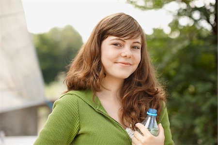 Young girl smiling at camera with water Stock Photo - Premium Royalty-Free, Code: 649-03771646