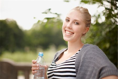 Young girl smiling at camera with water Stock Photo - Premium Royalty-Free, Code: 649-03771648