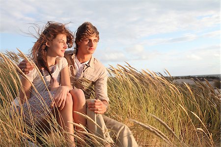 simsearch:649-03771772,k - Young couple in the dunes at sunset Fotografie stock - Premium Royalty-Free, Codice: 649-03771771