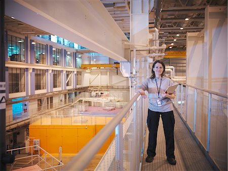 Scientist in particle accelerator hall Stock Photo - Premium Royalty-Free, Code: 649-03771972