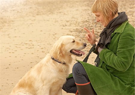 suffolk - Woman training dog on beach Autumn Fall Stock Photo - Premium Royalty-Free, Code: 649-03773170