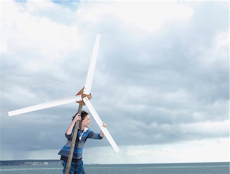 energy concept fun - Boy with wind turbine Stock Photo - Premium Royalty-Free, Code: 649-03773277