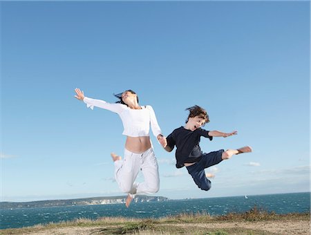 people young jumping happy - Freedom Stock Photo - Premium Royalty-Free, Code: 649-03773298