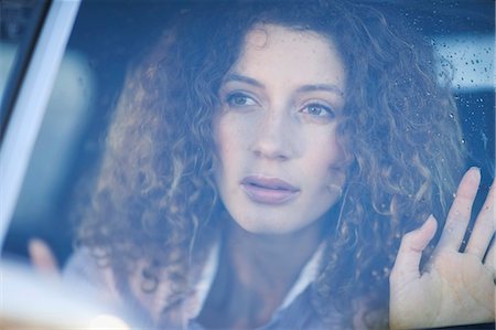 Woman looking out of a car window Stock Photo - Premium Royalty-Free, Code: 649-03796171