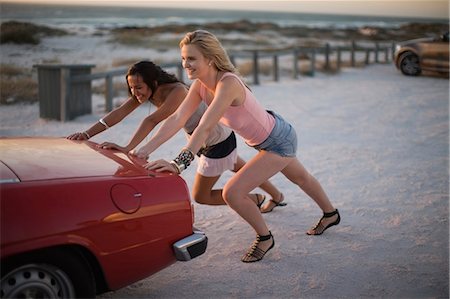 summer car trouble - Girls pushing their broken car Stock Photo - Premium Royalty-Free, Code: 649-03796277