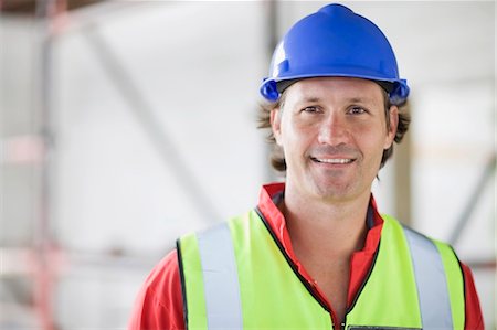 smiling engineer portrait - Smiling worker with hat Stock Photo - Premium Royalty-Free, Code: 649-03796448