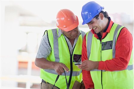 engineer on phone - Building workers writing an sms Stock Photo - Premium Royalty-Free, Code: 649-03796493