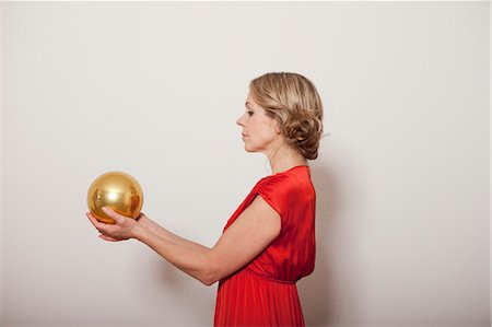 Woman holding a golden ball Stock Photo - Premium Royalty-Free, Code: 649-03796586