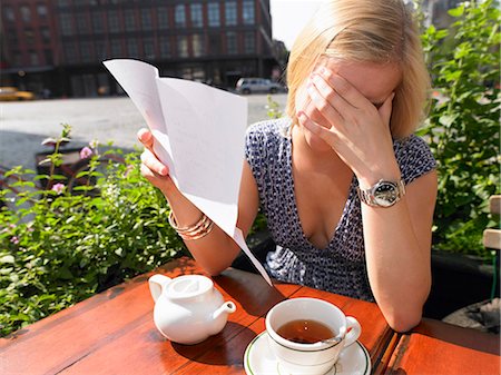 Woman reading a sad letter Stock Photo - Premium Royalty-Free, Code: 649-03796719